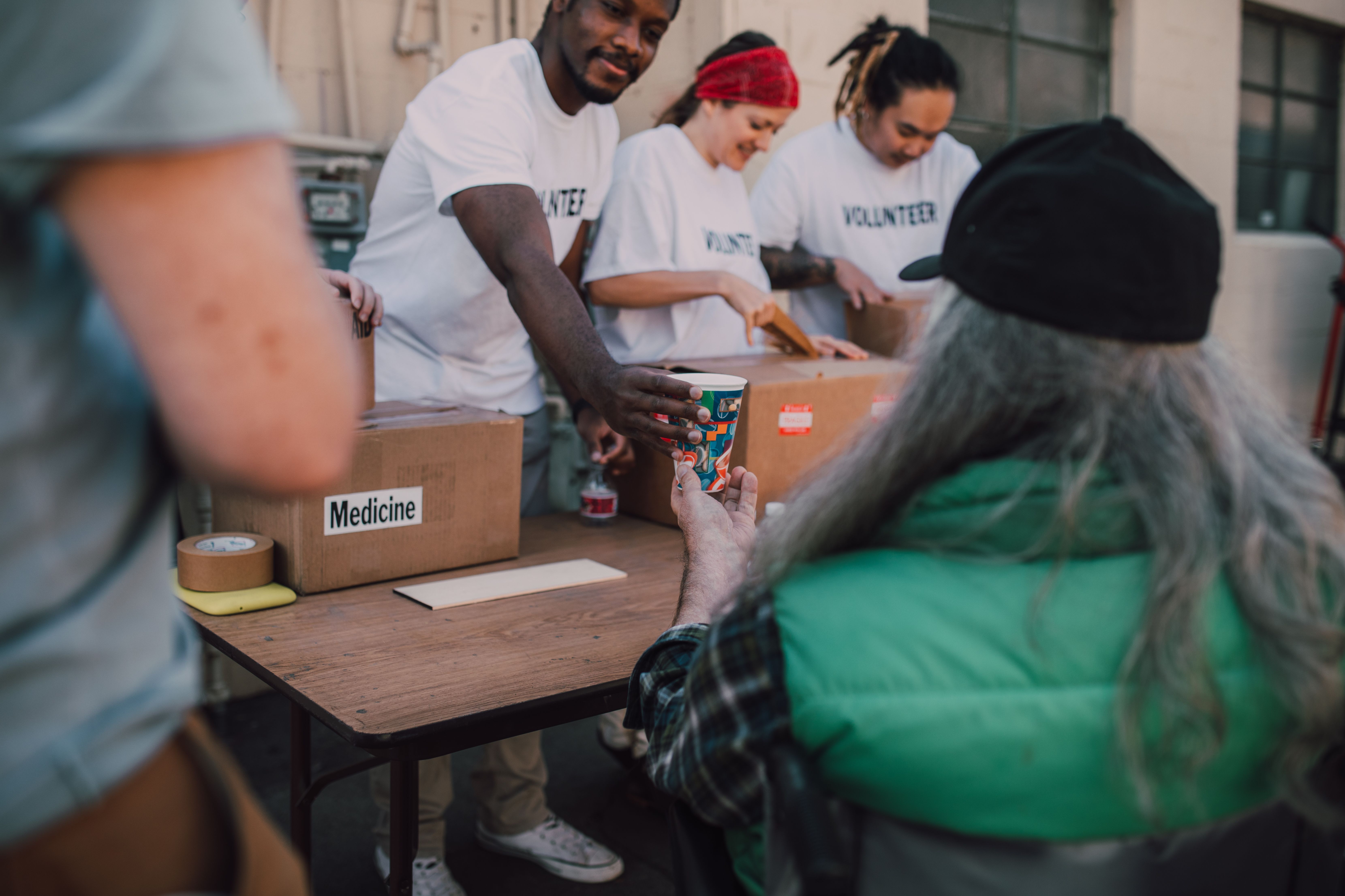 Volunteers handing out donations and support to people in need at a community event
